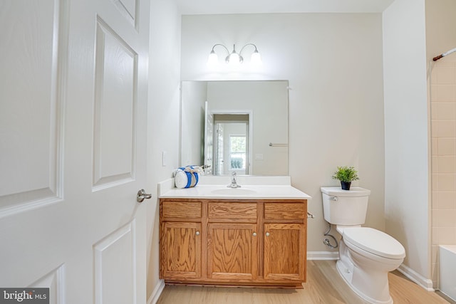 full bathroom with shower / bathing tub combination, vanity, hardwood / wood-style flooring, and toilet