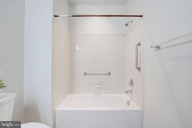 bathroom featuring toilet and tiled shower / bath