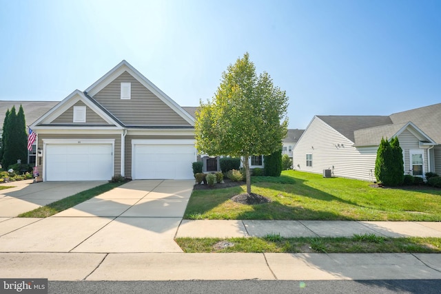 view of front facade with a front yard, a garage, and central AC unit