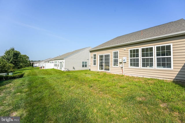 back of house with a yard