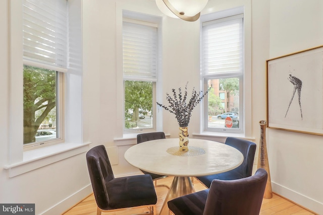 dining space with plenty of natural light and light hardwood / wood-style floors