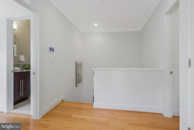 hall with crown molding and light hardwood / wood-style flooring