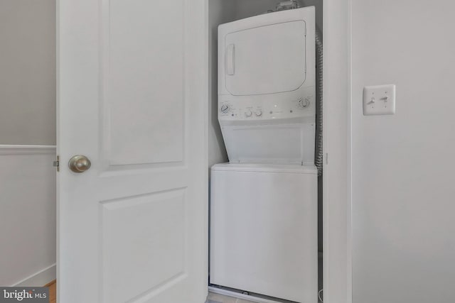 laundry area with stacked washing maching and dryer