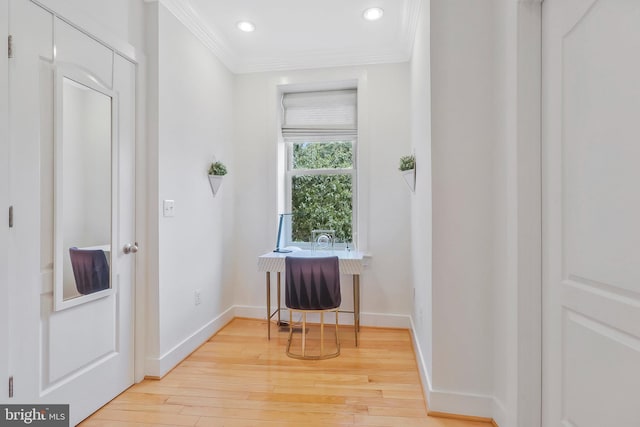 interior space featuring light wood-type flooring and ornamental molding