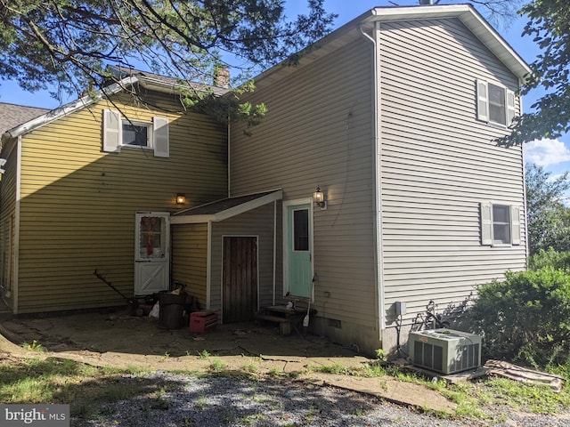 rear view of house featuring central AC