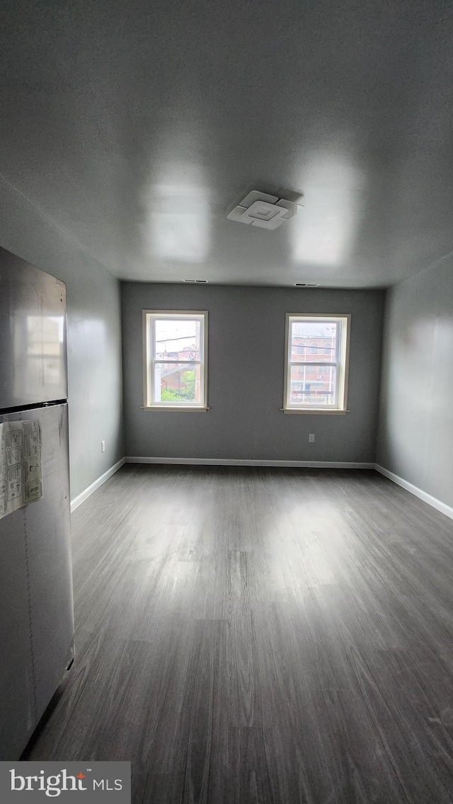 unfurnished living room featuring dark hardwood / wood-style flooring