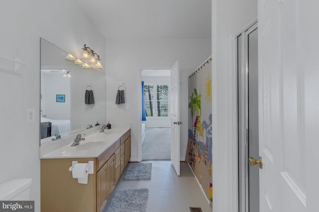 bathroom with tile patterned floors, dual bowl vanity, and toilet