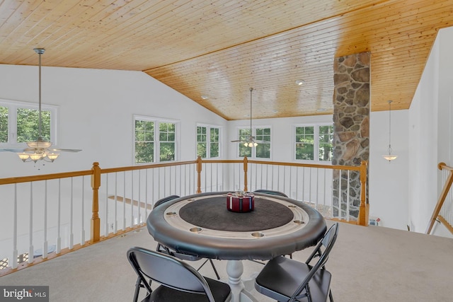 carpeted dining area featuring a healthy amount of sunlight, vaulted ceiling, wood ceiling, and ceiling fan