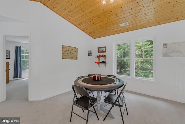 dining room with high vaulted ceiling, carpet floors, and wooden ceiling