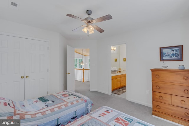 carpeted bedroom with ceiling fan, connected bathroom, and a closet