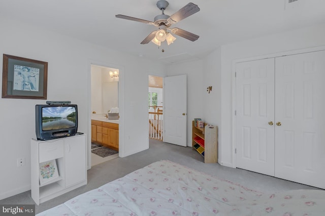 bedroom featuring a closet, ensuite bathroom, carpet floors, and ceiling fan