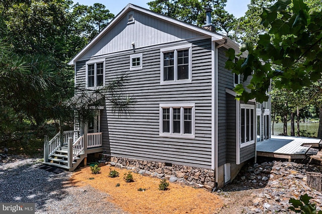 view of property exterior featuring a wooden deck