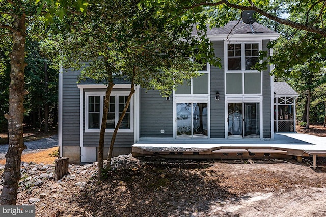 rear view of house with a wooden deck