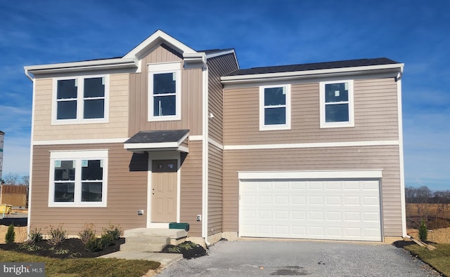 view of front of home featuring a front yard and a garage