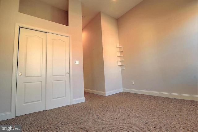 unfurnished bedroom featuring carpet and a closet