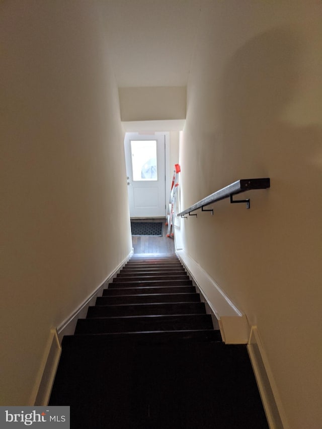 staircase with hardwood / wood-style flooring