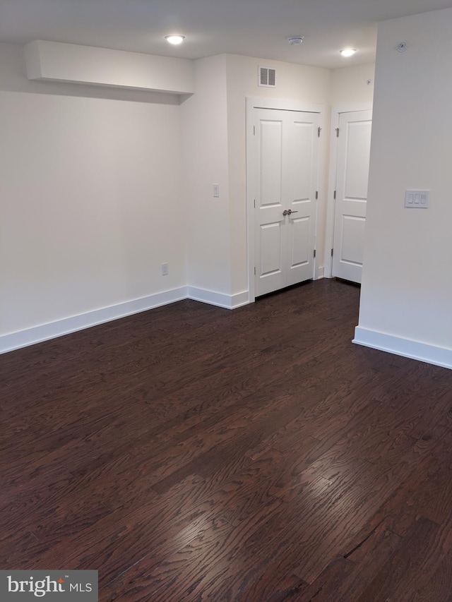 unfurnished room featuring dark hardwood / wood-style flooring