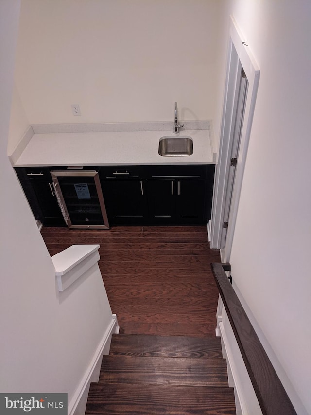 stairs featuring hardwood / wood-style floors and sink