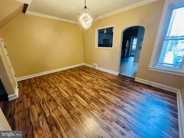 unfurnished dining area with dark wood-type flooring and crown molding