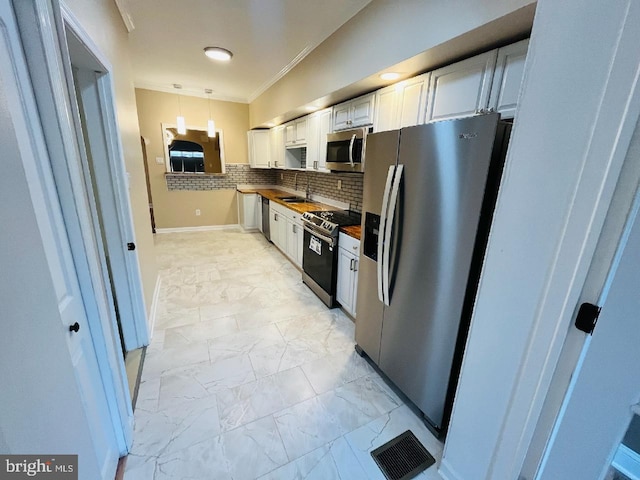 kitchen with white cabinetry, wooden counters, stainless steel appliances, backsplash, and hanging light fixtures