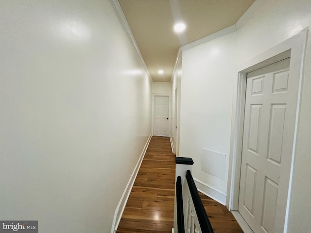 hallway featuring ornamental molding and dark hardwood / wood-style floors