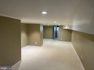 basement with crown molding and light colored carpet