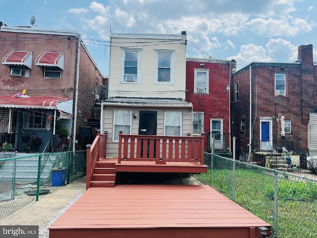 rear view of property featuring a deck