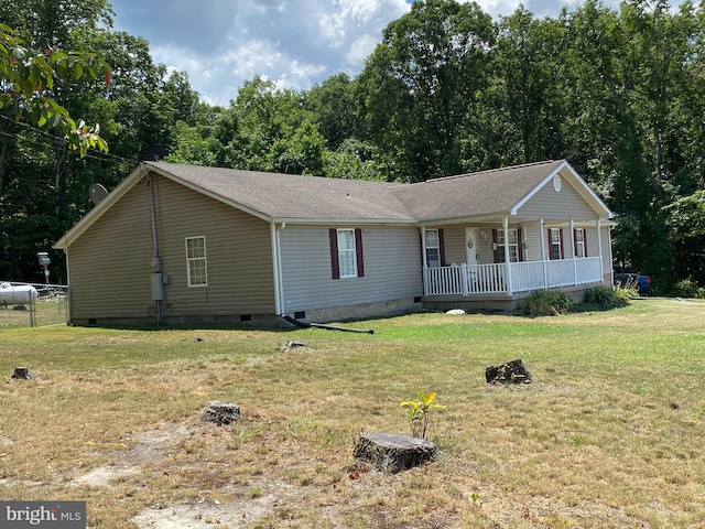 ranch-style home with covered porch and a front lawn