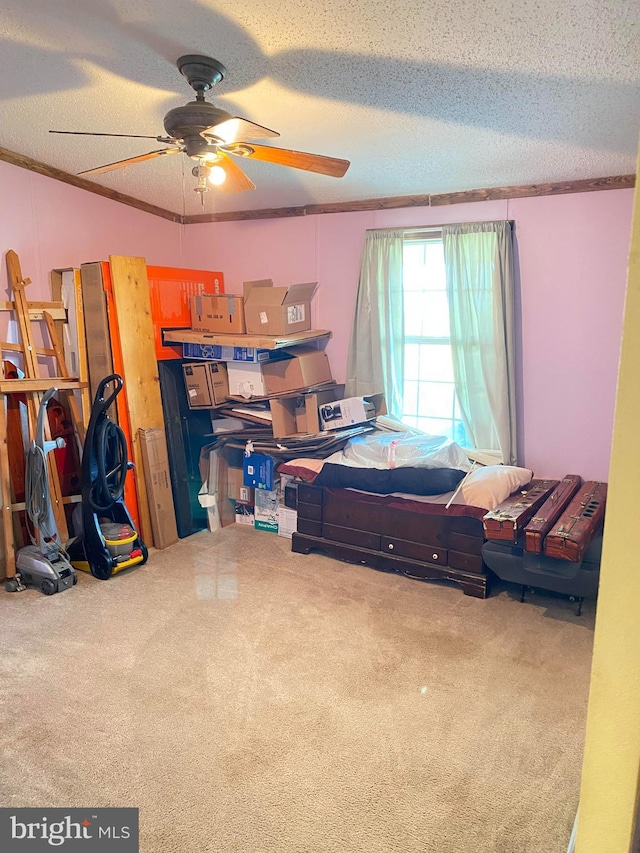 carpeted bedroom featuring ceiling fan, a textured ceiling, and ornamental molding