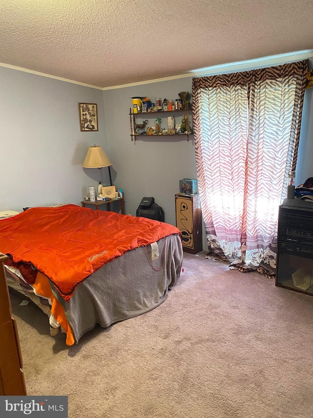 carpeted bedroom with a textured ceiling and ornamental molding