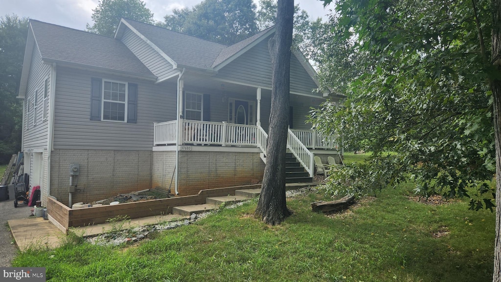 37680 Frischholz Ct, Mechanicsville, MD 20659 - rear view of house featuring covered porch and a lawn
