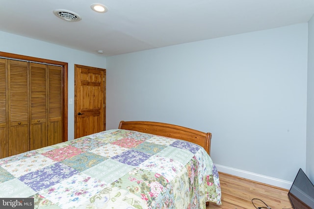 bedroom with a closet and light hardwood / wood-style floors