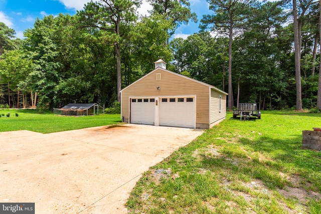 view of property exterior with a garage, an outdoor structure, and a lawn