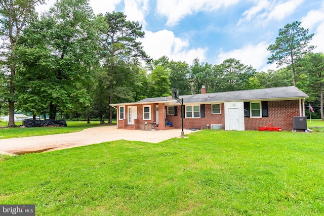 single story home featuring cooling unit and a front yard