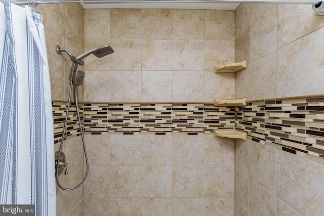 interior details featuring a shower with shower curtain