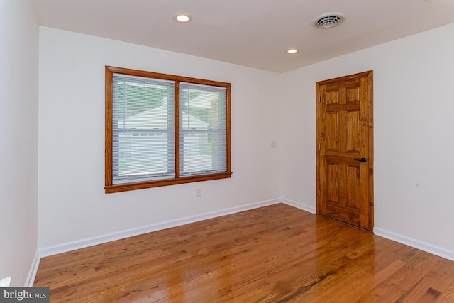 unfurnished room featuring hardwood / wood-style floors