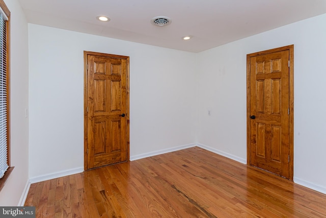 empty room featuring hardwood / wood-style flooring