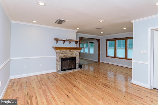 unfurnished living room with light hardwood / wood-style flooring and crown molding