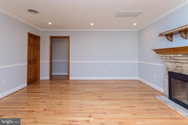 unfurnished living room featuring a fireplace, light hardwood / wood-style floors, and crown molding