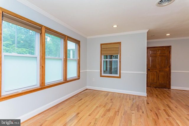 unfurnished room featuring light hardwood / wood-style floors and ornamental molding