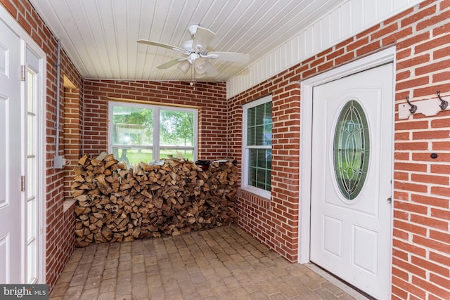 entrance to property featuring ceiling fan and covered porch