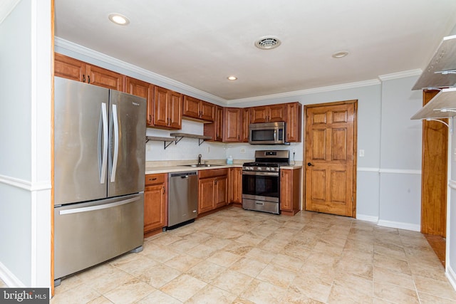 kitchen featuring sink, ornamental molding, and appliances with stainless steel finishes