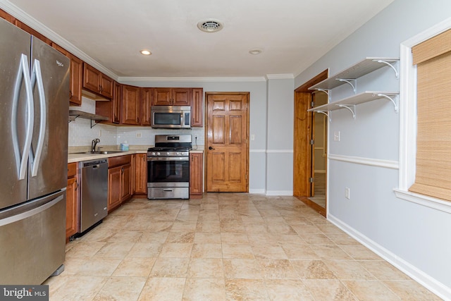 kitchen with decorative backsplash, crown molding, sink, and appliances with stainless steel finishes