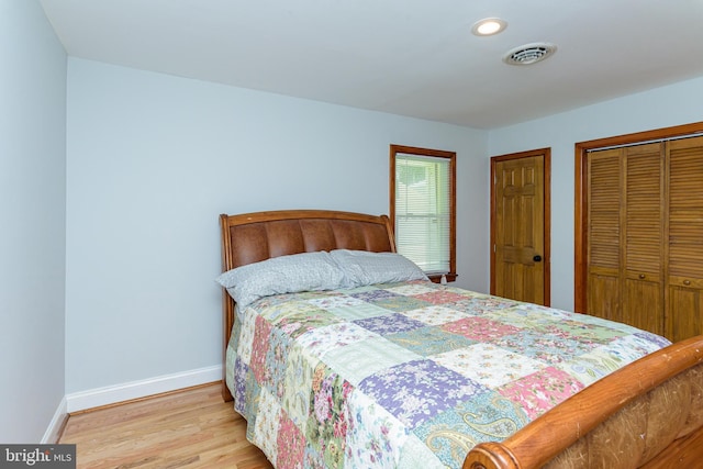 bedroom featuring light wood-type flooring and a closet