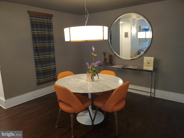 dining space featuring dark hardwood / wood-style floors