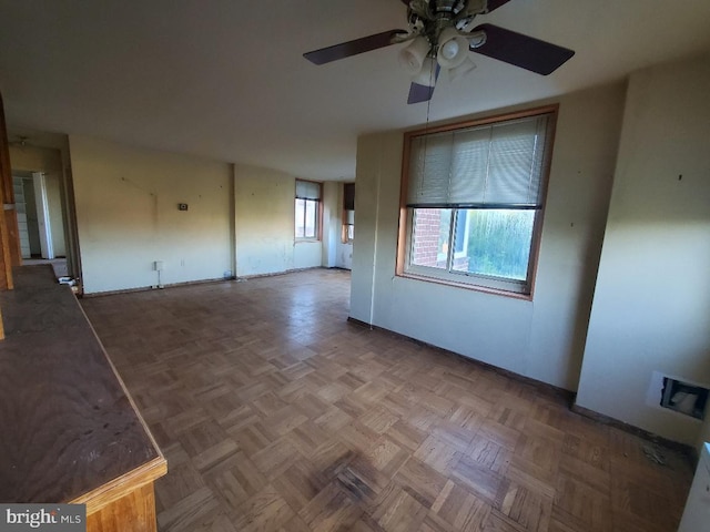 empty room featuring ceiling fan and parquet floors