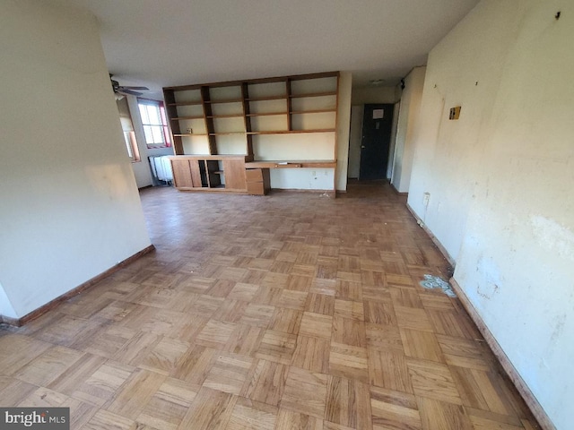 unfurnished living room featuring ceiling fan and light parquet floors