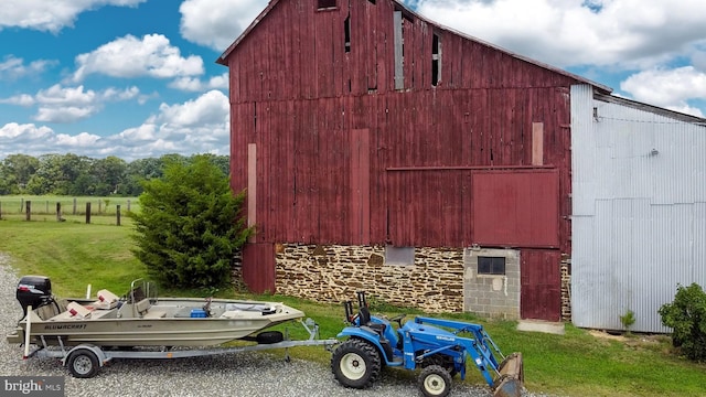 view of outbuilding with a yard