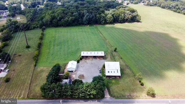 view of front of property with central AC and a front lawn