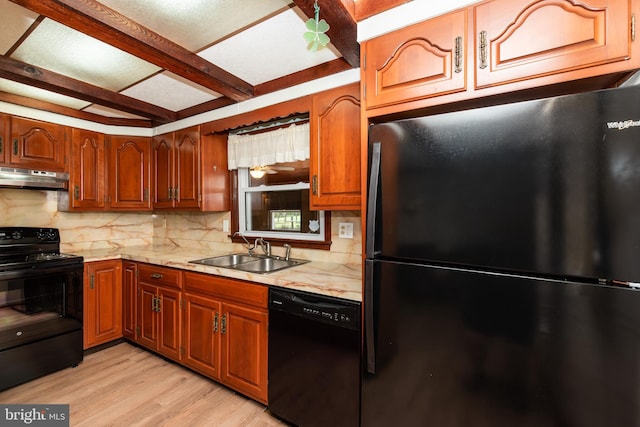 kitchen featuring beamed ceiling, sink, light hardwood / wood-style floors, black appliances, and light stone countertops